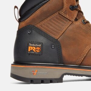 Close up of Timberland Ballast safety toe men's 6-inch work boot in brown showing composite toe tag with a blank background.