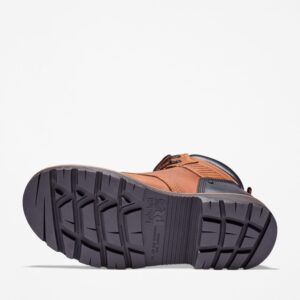The sole of the right boot on a Timberland Ballast steel toe men's 6-inch work boots in brown with a blank background.