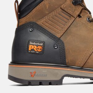 Close up of Timberland Ballast non-safety toe men's 6-inch work boot in tan showing soft toe tag with a blank background.