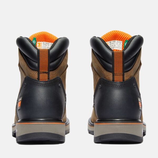 A look at the heels of a pair of Timberland Ballast soft toe men's 6-inch work boots in tan with a blank background.