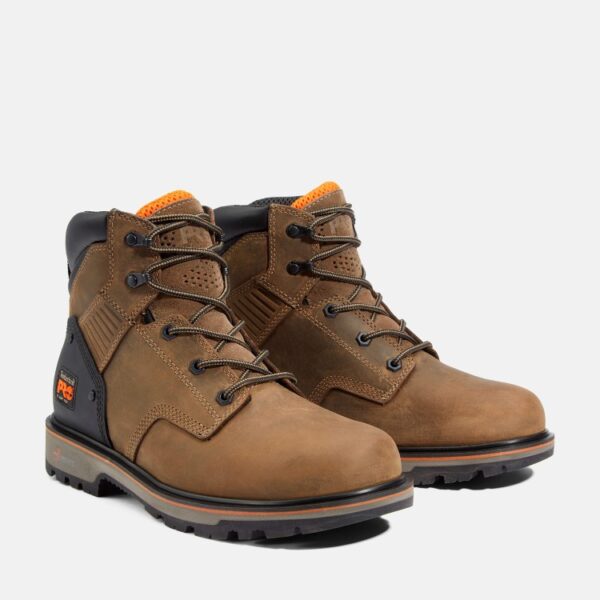 A turned pair of Timberland Ballast soft toe men's 6-inch work boots in tan with a blank background.