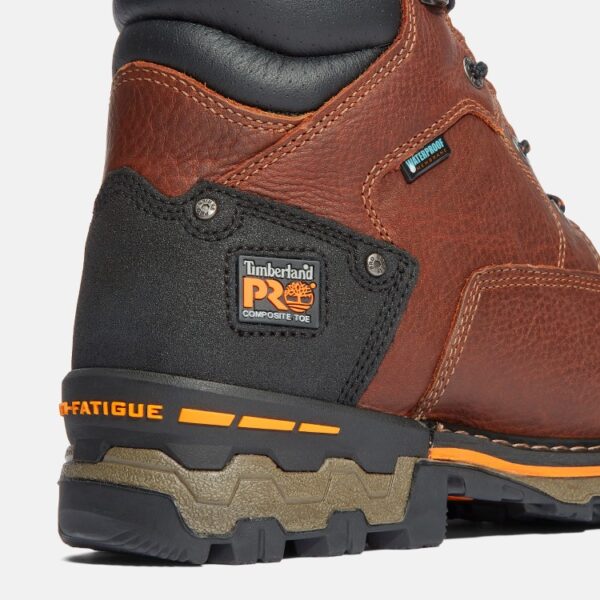 Close up of Timberland Boondock safety toe 6-inch waterproof insulated men's work boot in brown showing composite toe tag with a blank background.