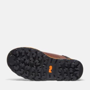 The sole of the right boot on a Timberland Boondock composite toe 6-inch waterproof insulated men's work boot in brown with a blank background.