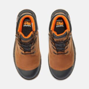 Overhead shot of a pair of Timberland Boondock soft toe 6-inch waterproof men's work boots in tan with a blank background.