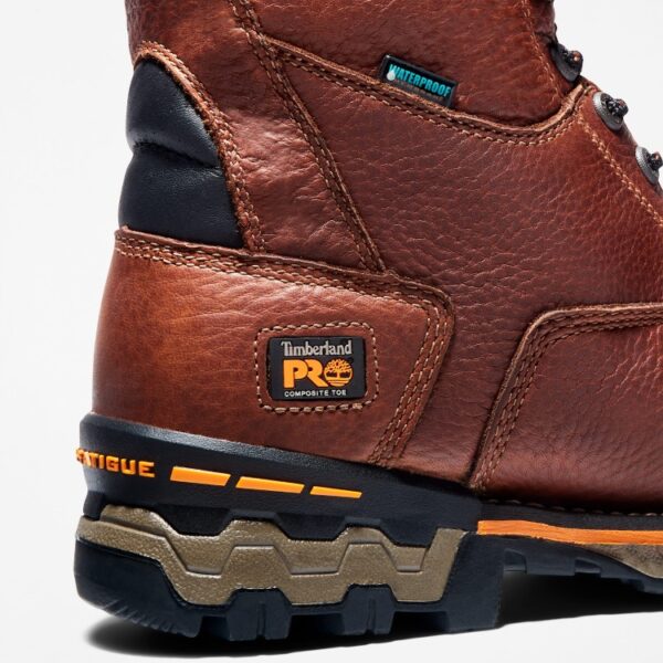Close up of Timberland Boondock safety toe waterproof 8-inch men's work boot in brown showing composite toe tag with a blank background.