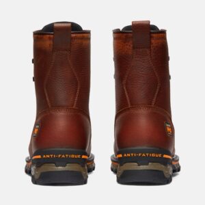 A look at the heels of a pair of Timberland Boondock composite toe waterproof 8-inch men's work boots in brown with a blank background.