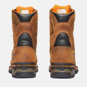 A look at the heels of a pair of Timberland Boondock composite toe 8-inch waterproof men's work boots in tan with a blank background.