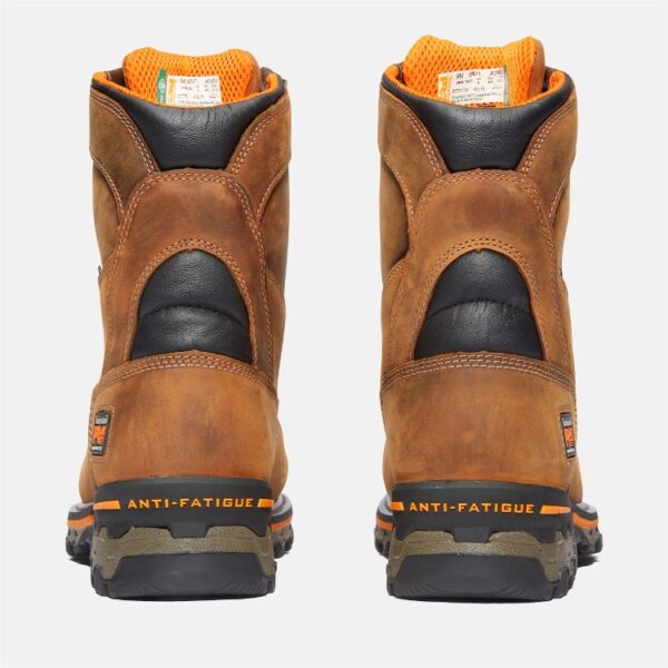 A look at the heels of a pair of Timberland Boondock composite toe 8-inch waterproof men's work boots in tan with a blank background.