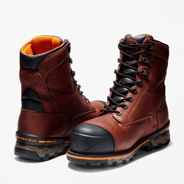 Offset pair of Timberland Boondock composite toe 8-inch waterproof men's work boots in brown with a blank background.