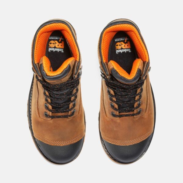 Overhead shot of a pair of Timberland Boondock composite toe 8-inch waterproof men's work boots in tan with a blank background.