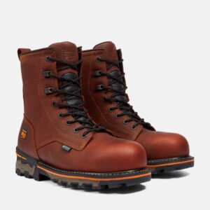 A turned pair of Timberland Boondock composite toe 8-inch waterproof men's work boots in brown with a blank background.