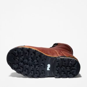 The sole of the right boot on a Timberland Boondock composite toe 8-inch waterproof men's work boot in brown with a blank background.
