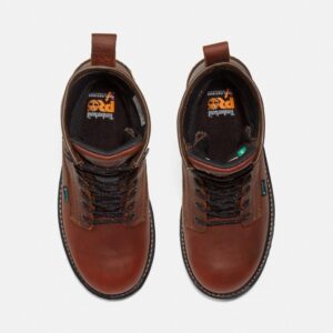 Overhead shot of a pair of Timberland Boondock waterproof soft toe 8-inch men's work boots in brown with a blank background.