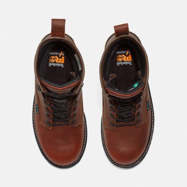 Overhead shot of a pair of Timberland Boondock waterproof soft toe 8-inch men's work boots in brown with a blank background.