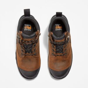 Overhead look at a pair of Timberland Boondock HD composite toe waterproof insulated men's 6-inch work boots in brown on a blank background.