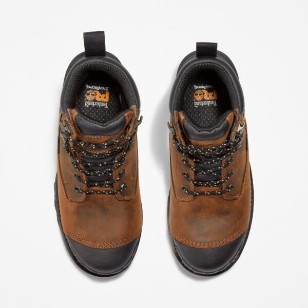 Overhead look at a pair of Timberland Boondock HD composite toe waterproof insulated men's 6-inch work boots in brown on a blank background.