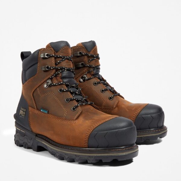 A turned pair of Timberland Boondock HD composite toe waterproof insulated men's 6-inch work boots in brown with a blank background.
