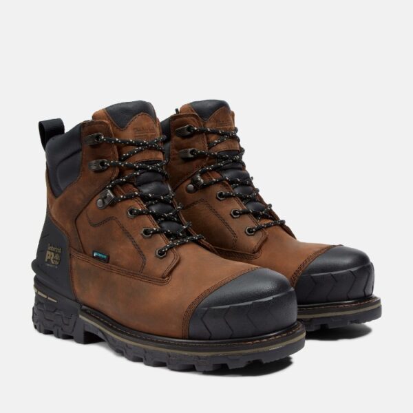A turned pair of Timberland Boondock HD composite toe waterproof men's 6-inch work boots in brown with a blank background.