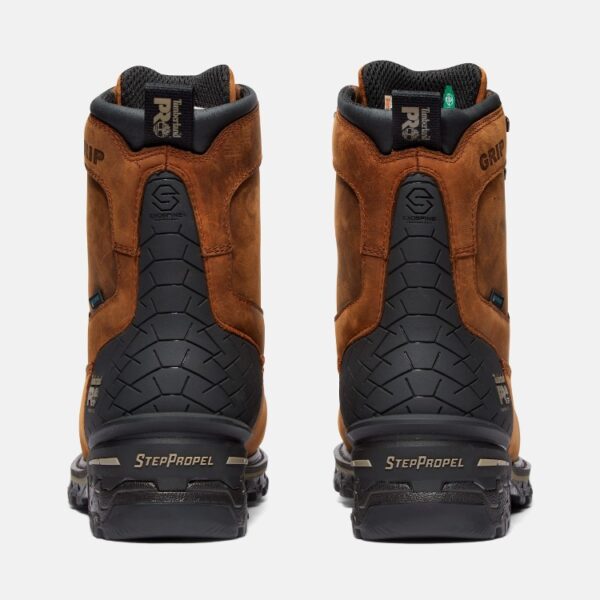A look at the heels of a pair of Timberland Boondock composite toe waterproof men's 8-inch work boots in brown with a blank background.