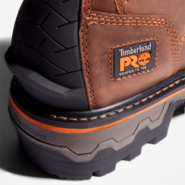 Close up of Timberland Boondock HD Logger safety toe waterproof men's work boot in brown showing composite toe tag with a blank background.