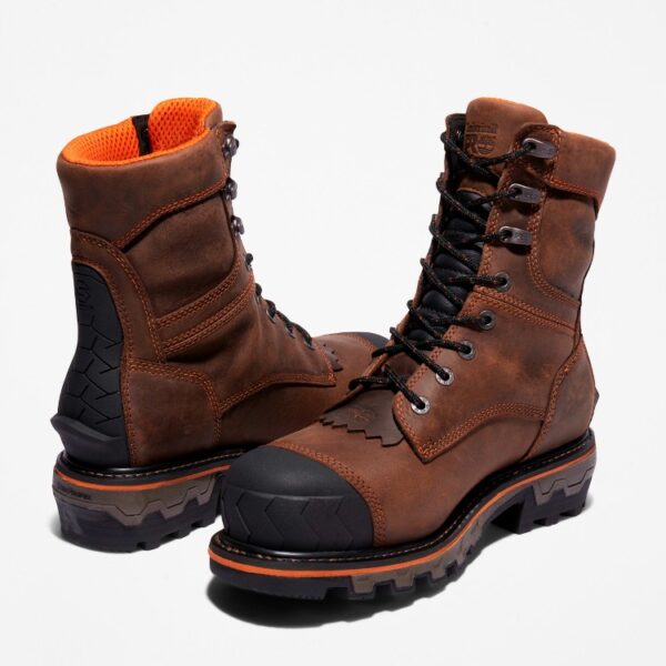 Offset pair of Timberland Boondock HD Logger composite toe waterproof men's work boots in brown with a blank background.