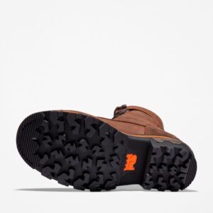 The sole of the right boot on a Timberland Boondock HD Logger composite toe waterproof men's work boot in brown with a blank background.