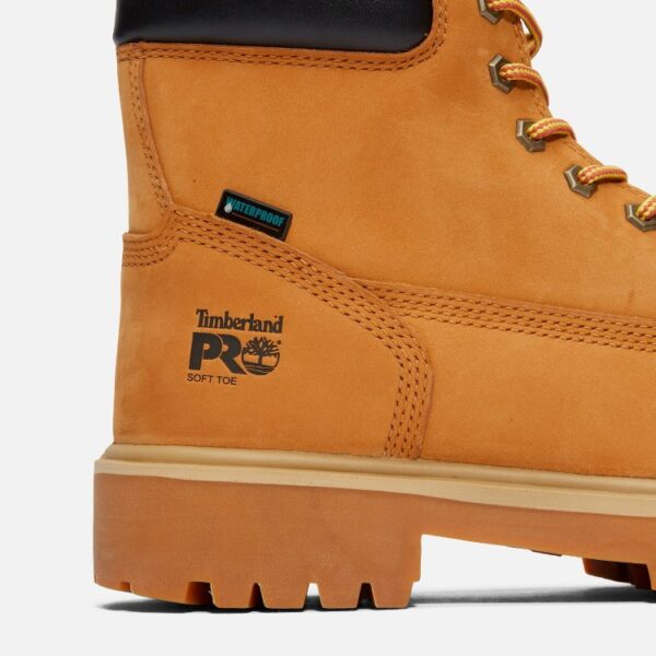 Close up of Timberland Direct Attach waterproof soft toe 6-inch men's work boot in wheat color showing waterproof tag with a blank background.