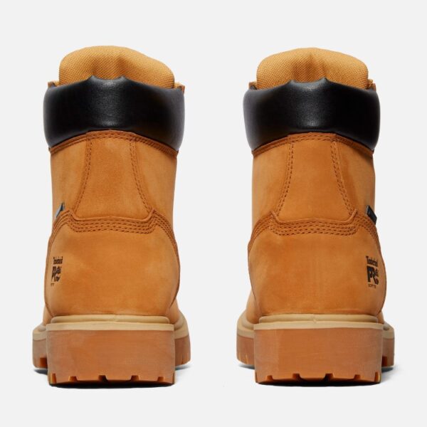 A look at the heels of a pair of Timberland Direct Attach soft toe waterproof 6-inch men's work boots in wheat color with a blank background.