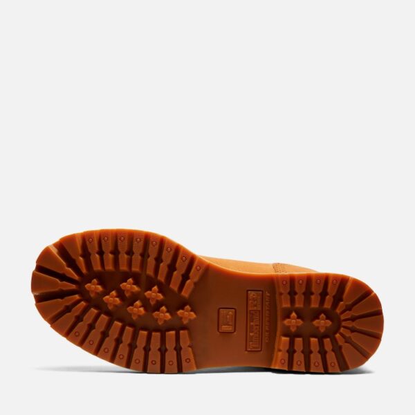 The sole of the right boot on a Timberland Direct Attach soft toe waterproof 6-inch men's work boot in wheat color with a blank background.