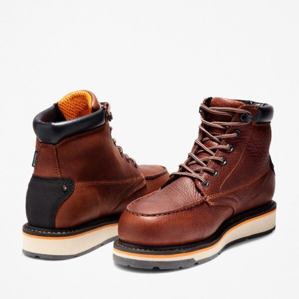 Offset pair of Timberland Gridworks alloy toe waterproof men's 6-inch work boots in brown with a blank background.
