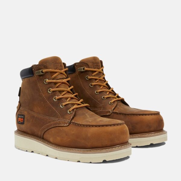 A turned pair of Timberland Gridworks alloy toe waterproof men's 6-inch work boots in light brown with a blank background.