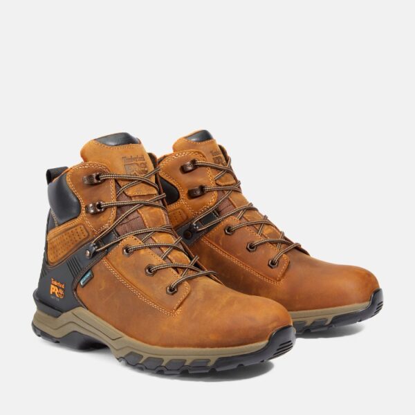 A turned pair of Timberland Hypercharge soft toe waterproof men's 6-inch work boots in tan with a blank background.