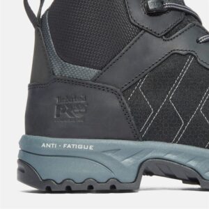 Close up of Timberland Payload safety toe men's 6-inch work boot in black and gray showing composite toe stamp and anti-fatigue marking with a blank background.