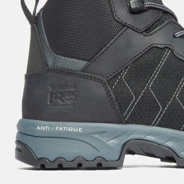 Close up of Timberland Payload safety toe men's 6-inch work boot in black and gray showing composite toe stamp and anti-fatigue marking with a blank background.