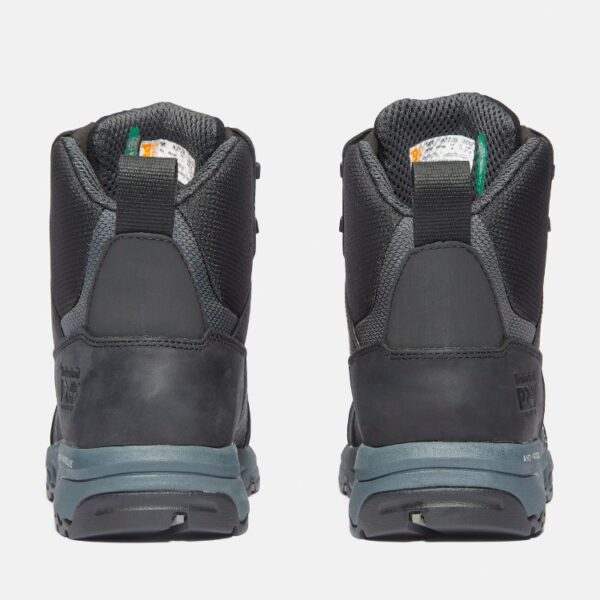 A look at the heels of a pair of Timberland Payload composite toe men's 6-inch work boots in black and gray with a blank background.