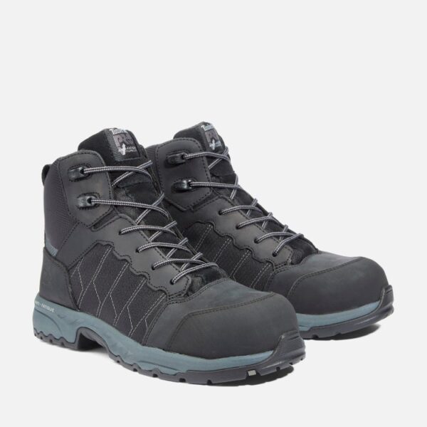 A turned pair of Timberland Payload composite toe men's 6-inch work boots in black and gray with a blank background.
