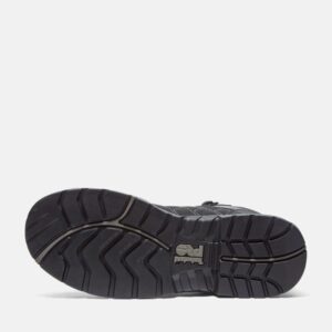The sole of the right boot on a Timberland Payload composite toe men's 6-inch work boots in black and gray with a blank background.