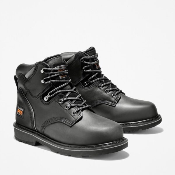 A turned pair of Timberland Pit Boss steel toe 6-inch men's work boots in black with a blank background.