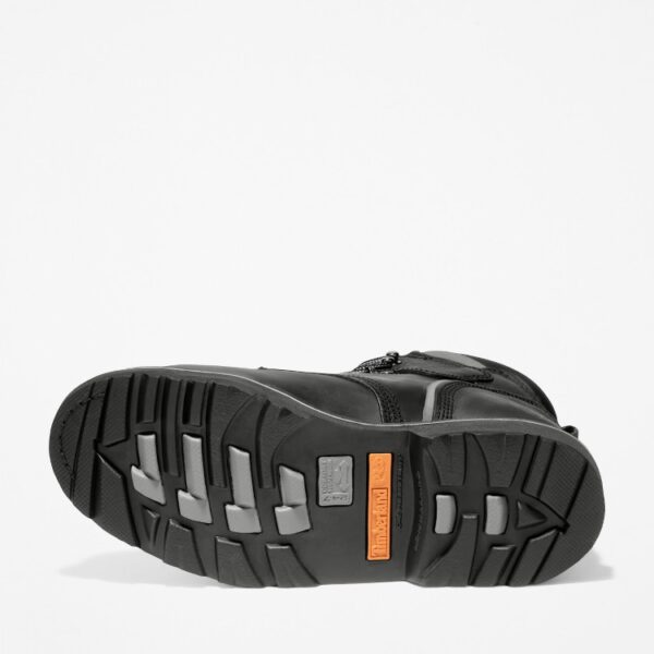 The sole of the right boot on a Timberland Pit Boss steel toe 6-inch men's work boot in black with a blank background.