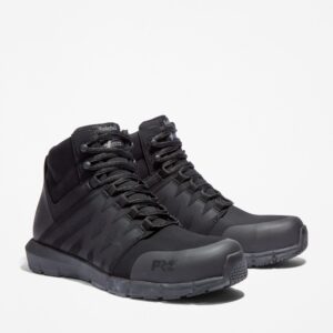 A turned pair of Timberland Radius composite toe high top men's work sneakers in black with a blank background.