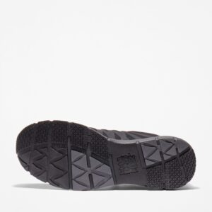 The sole of the right boot on a Timberland Radius composite toe men's low top work sneakers in black with a blank background.