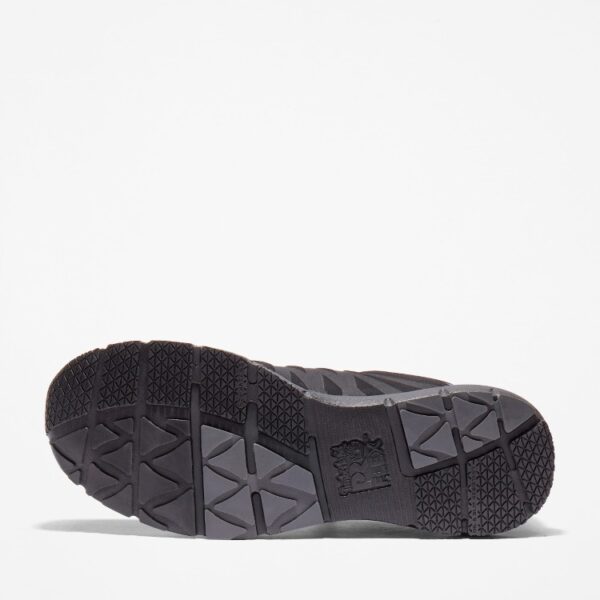 The sole of the right boot on a Timberland Radius composite toe men's low top work sneakers in black with a blank background.