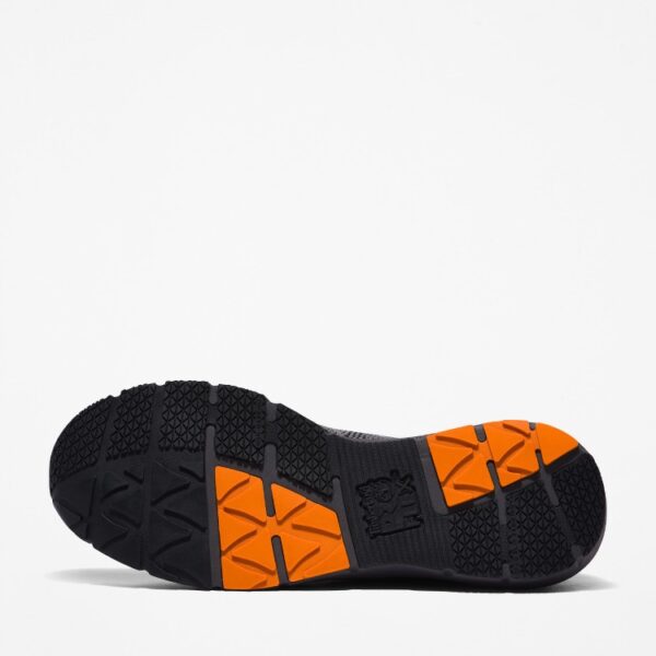 The sole of the right boot on a Timberland Radius composite toe men's work sneakers in gray and orange with a blank background.