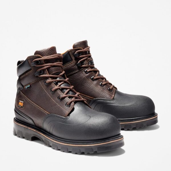 A turned pair of Timberland Rigmaster steel toe 6-inch waterproof men's work boots in brown with a blank background.