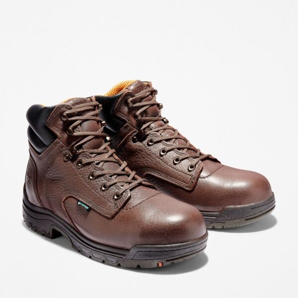 A turned pair of Timberland TiTAN Alloy Toe 6" Waterproof work boots in brown.