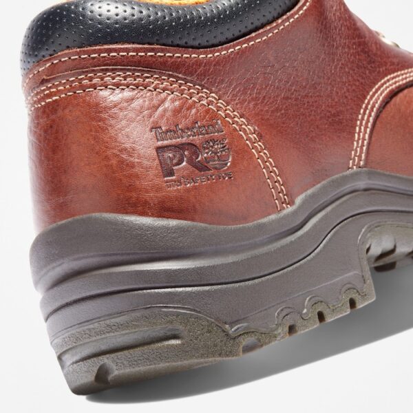 Close up of Timberland TiTAN casual alloy toe men's work shoe in brown showing safety toe imprint with a blank background.