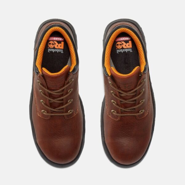Overhead shot of a pair of Timberland TiTAN casual alloy toe men's work shoes in brown with a blank background.