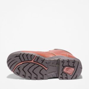 The sole of the right boot on a Timberland TiTAN casual alloy toe men's work shoe in brown with a blank background.