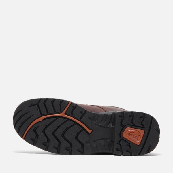 The sole of the right boot on a Timberland TiTAN casual soft toe men's work shoe in brown with a blank background.