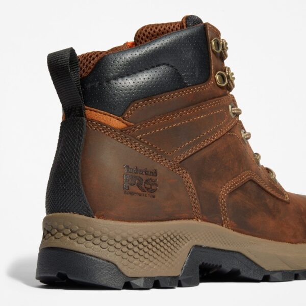 Close up of Timberland TiTAN EV safety toe men's 6-inch work boot in brown showing composite toe stamp with a blank background.